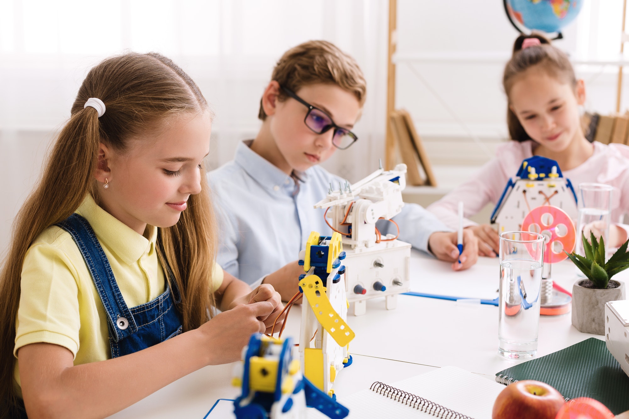 Schoolgirl making diy robot at stem lab